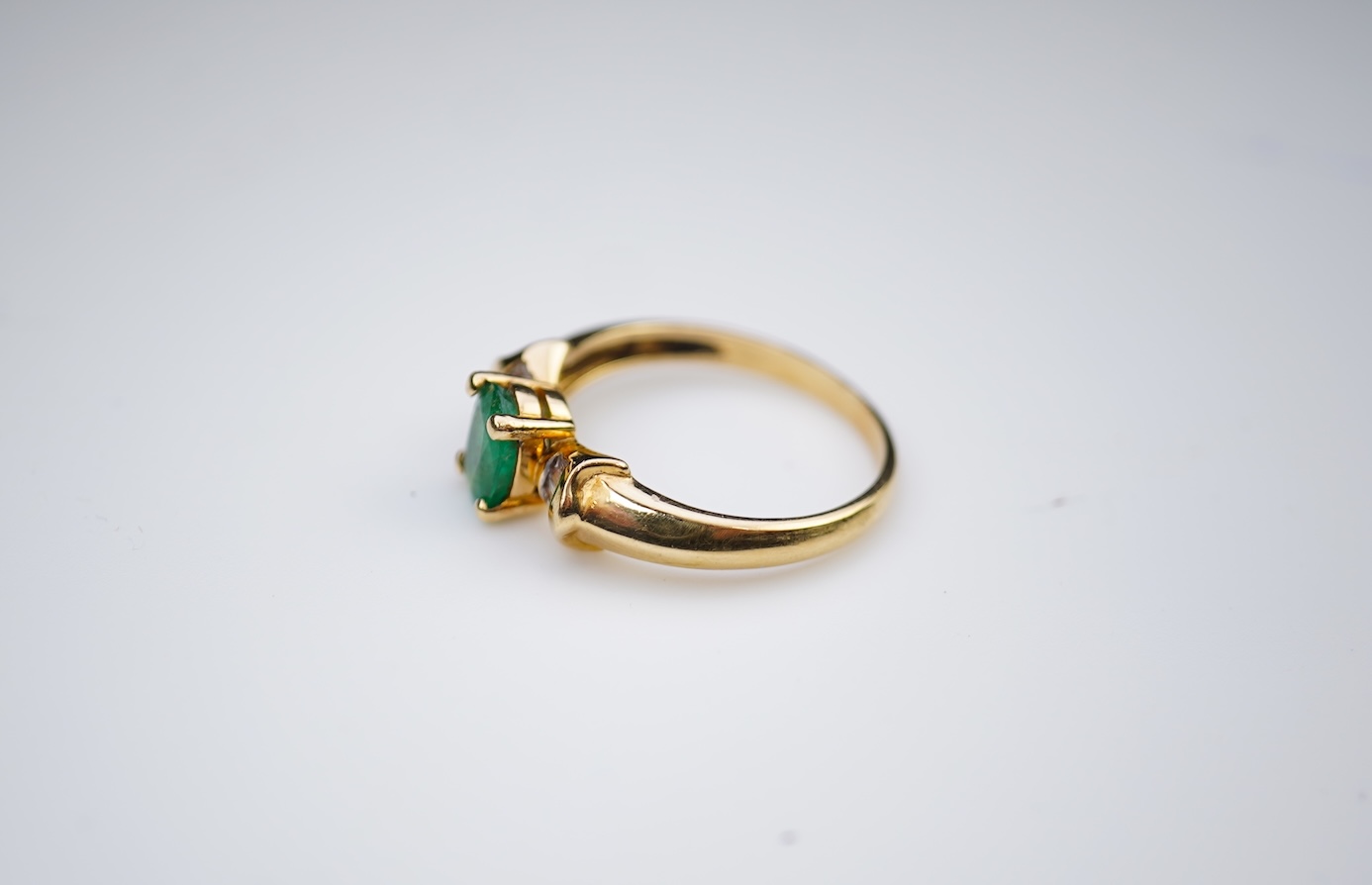 An emerald and diamond ring